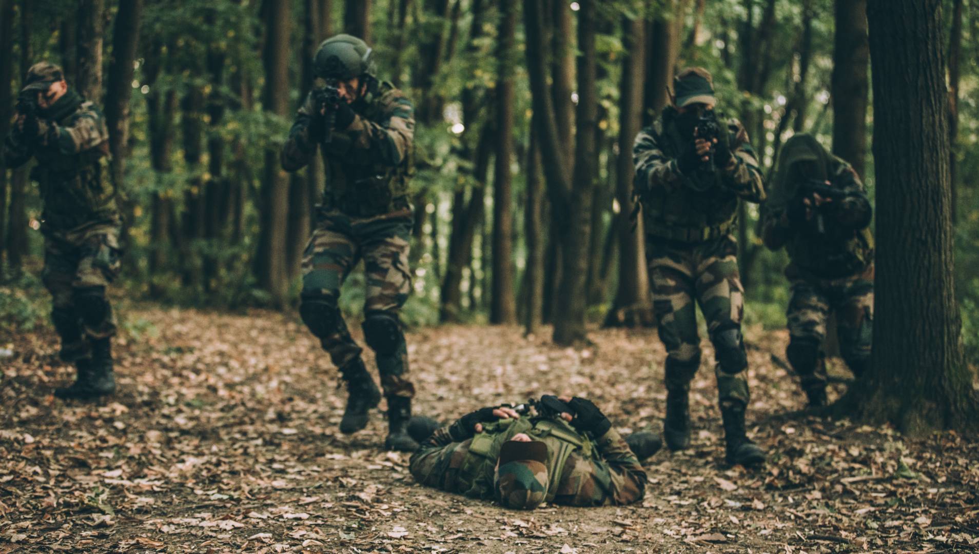 Soldiers fighting in forest combat scenario